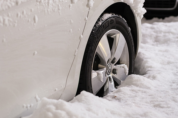 wheel of a white car stuck in the snow