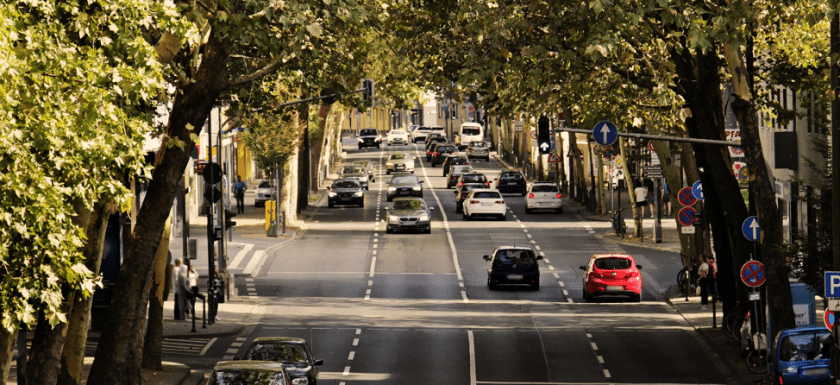 cars on a main town road, drive defensively
